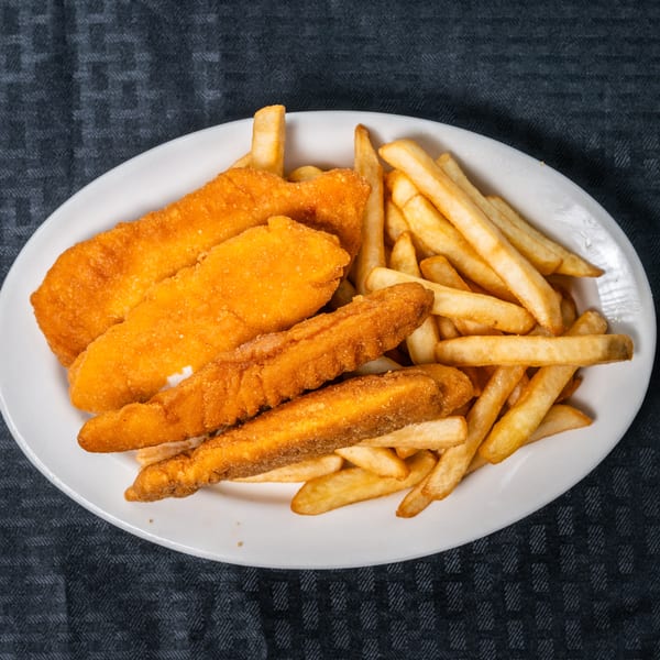 Golden fried chicken tenders and crispy french fries on a white plate.