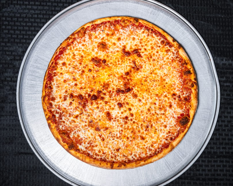 A classic cheese pizza with golden crust and melted cheese on a metal pan.